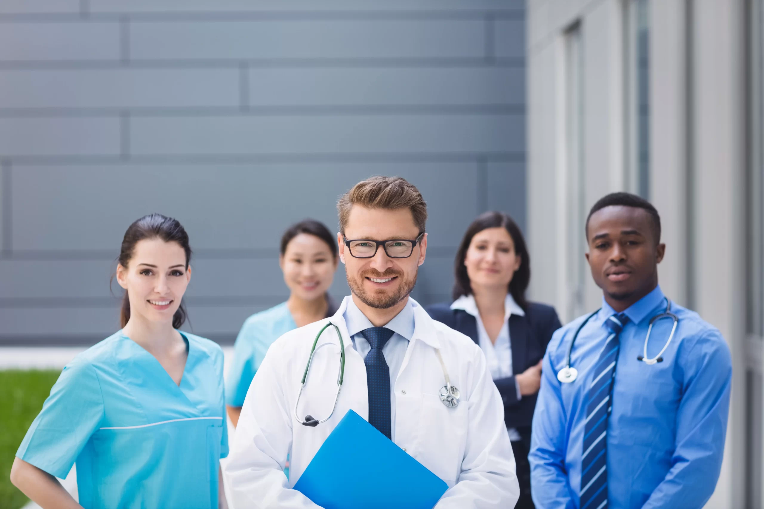 team doctors standing together hospital premises scaled