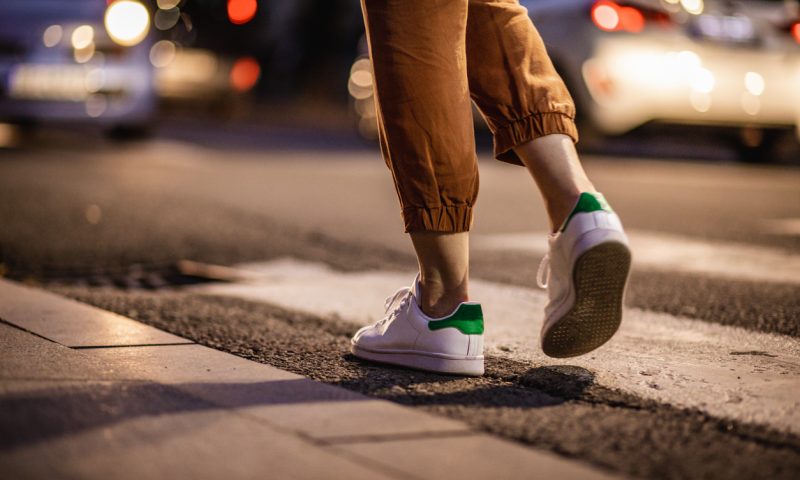 Photo of woman's legs on the zebra crossing